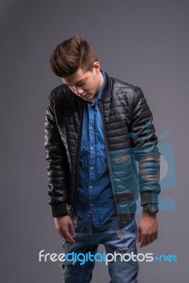 Casual Young Man In Black Leather Jacket And Denim Jeans Stock Photo