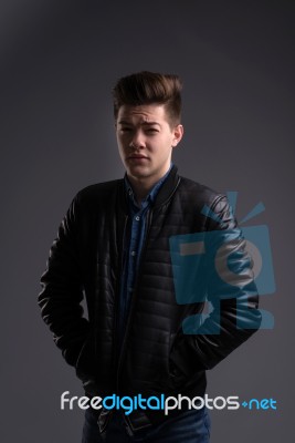 Casual Young Man In Black Leather Jacket And Denim Jeans Stock Photo