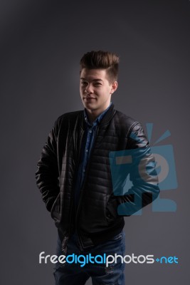 Casual Young Man In Black Leather Jacket And Denim Jeans Stock Photo