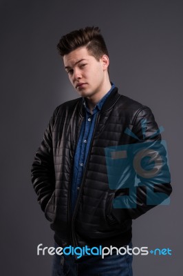 Casual Young Man In Black Leather Jacket And Denim Jeans Stock Photo