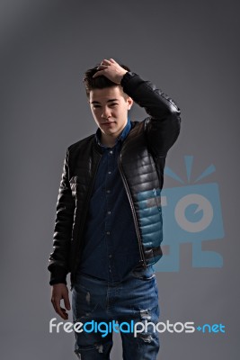 Casual Young Man In Black Leather Jacket And Denim Jeans Stock Photo