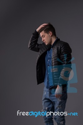 Casual Young Man In Black Leather Jacket And Denim Jeans Stock Photo