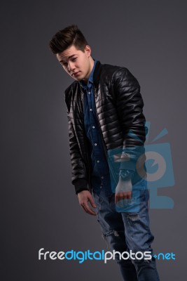 Casual Young Man In Black Leather Jacket And Denim Jeans Stock Photo