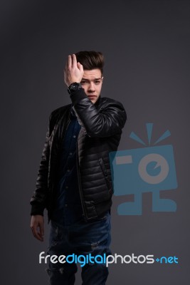 Casual Young Man In Black Leather Jacket And Denim Jeans Stock Photo