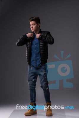 Casual Young Man In Black Leather Jacket And Denim Jeans Stock Photo