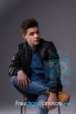 Casual Young Man In Black Leather Jacket And Denim Jeans Stock Photo