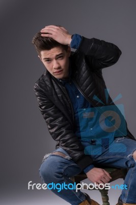 Casual Young Man In Black Leather Jacket And Denim Jeans Stock Photo