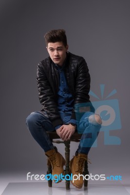 Casual Young Man In Black Leather Jacket And Denim Jeans Stock Photo