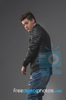 Casual Young Man In Black Leather Jacket And Denim Jeans Stock Photo