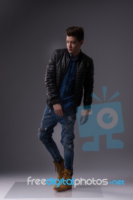 Casual Young Man In Black Leather Jacket And Denim Jeans Stock Photo