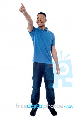 Casual Young Man Pointing Away Stock Photo