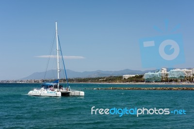 Catamaran Entering The Harbour In Marbella Stock Photo