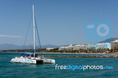 Catamaran Entering The Harbour In Marbella Stock Photo