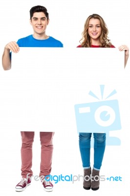 Caucasian Couple Holding An Ad Board Stock Photo