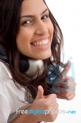 Caucasian Female Wearing Headphones And Gesturing Thumbs Up Stock Photo