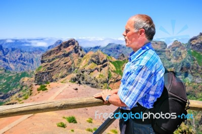 Caucasian Man Viewing Rocky Mountains In Landscape Stock Photo