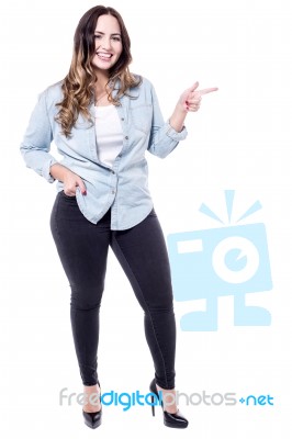 Caucasian Woman Pointing To Her Left Stock Photo