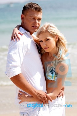 Caucasian Young Couples At Beach Stock Photo