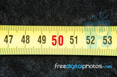 Centimeters Near A Tape Measure On The Number Fifty Stock Photo