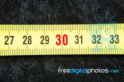 Centimeters Near A Tape Measure On The Number Thirty Stock Photo