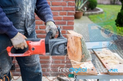 Chain Saw Cutting Wood Stock Photo