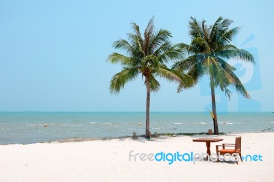 Chair And Table Set On The White Clean Sand Beach With Coconut Trees And Beautiful Sea Stock Photo