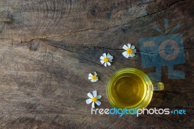 Chamomile Tea And Chamomile Flower On Old Wooden Table Stock Photo