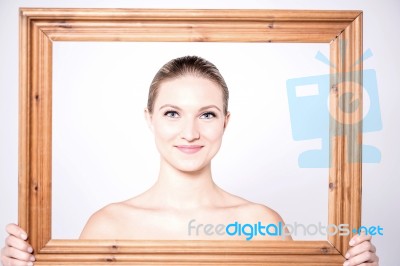 Charismatic Woman In A Wooden Frame Stock Photo