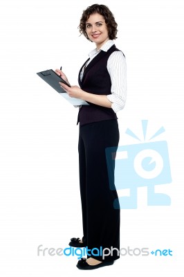 Charming Business Lady Posing With A Clipboard Stock Photo