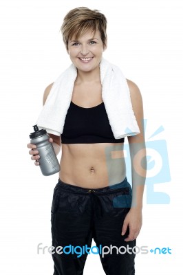 Charming Fit Lady Holding Up A Bottle Of Water Stock Photo