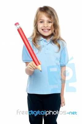 Charming Kid With Beautiful Hair Holding Red Pencil Stock Photo