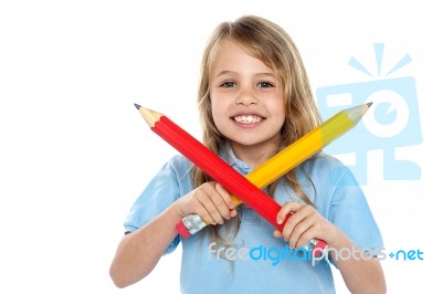 Charming School Girl Posing With Big Pencils Stock Photo