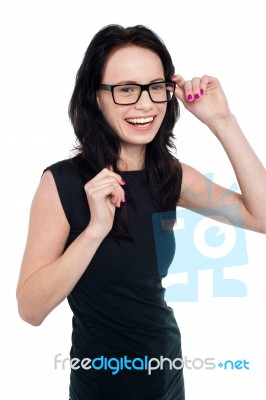 Charming Smiling Lady Adjusting Her Eyeglasses Stock Photo