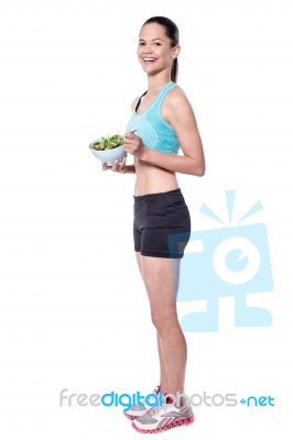 Charming Young Lady Eating Salad Stock Photo