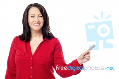 Cheerful Aged Woman Pointing To Her Left Stock Photo