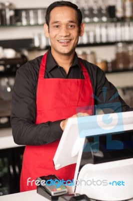 Cheerful Barista Staff At The Cash Counter Stock Photo