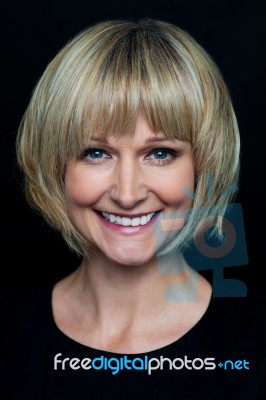 Cheerful Blonde Woman On Black Background Stock Photo