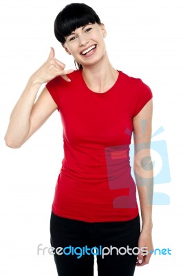 Cheerful Brunette Gesturing A Mock Call Stock Photo