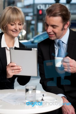 Cheerful Business People Using Digital Tablet Stock Photo