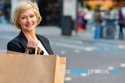 Cheerful Business Woman Holding Shopping Bag Stock Photo