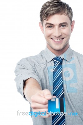 Cheerful Businessman Giving His Credit Card Stock Photo