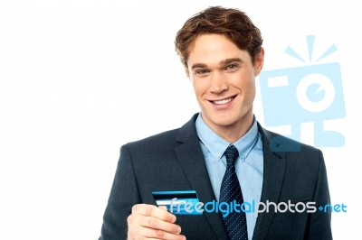 Cheerful Businessman Holding Credit Card Stock Photo