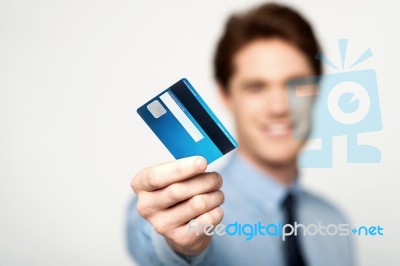 Cheerful Businessman Holding Credit Card Stock Photo