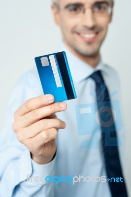 Cheerful Businessman Holding Credit Card Stock Photo