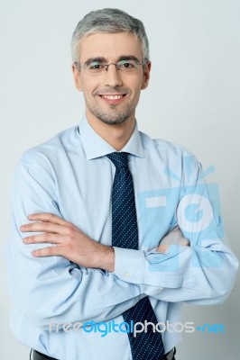 Cheerful Businessman With Arms Folded Stock Photo