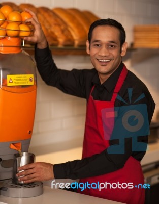 Cheerful Chef Making Fresh Orange Juice Stock Photo