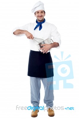 Cheerful Chef Mixing Batter In The Kitchen Stock Photo