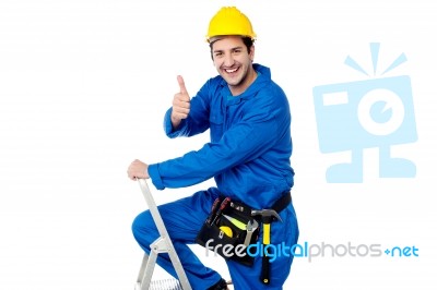 Cheerful Construction Worker On Ladder Stock Photo