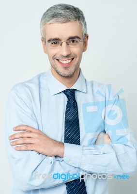 Cheerful Corporate Man With Arms Folded Stock Photo