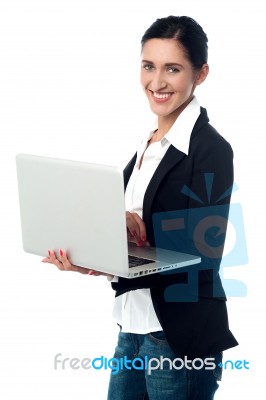 Cheerful Corporate Woman Using Laptop Stock Photo